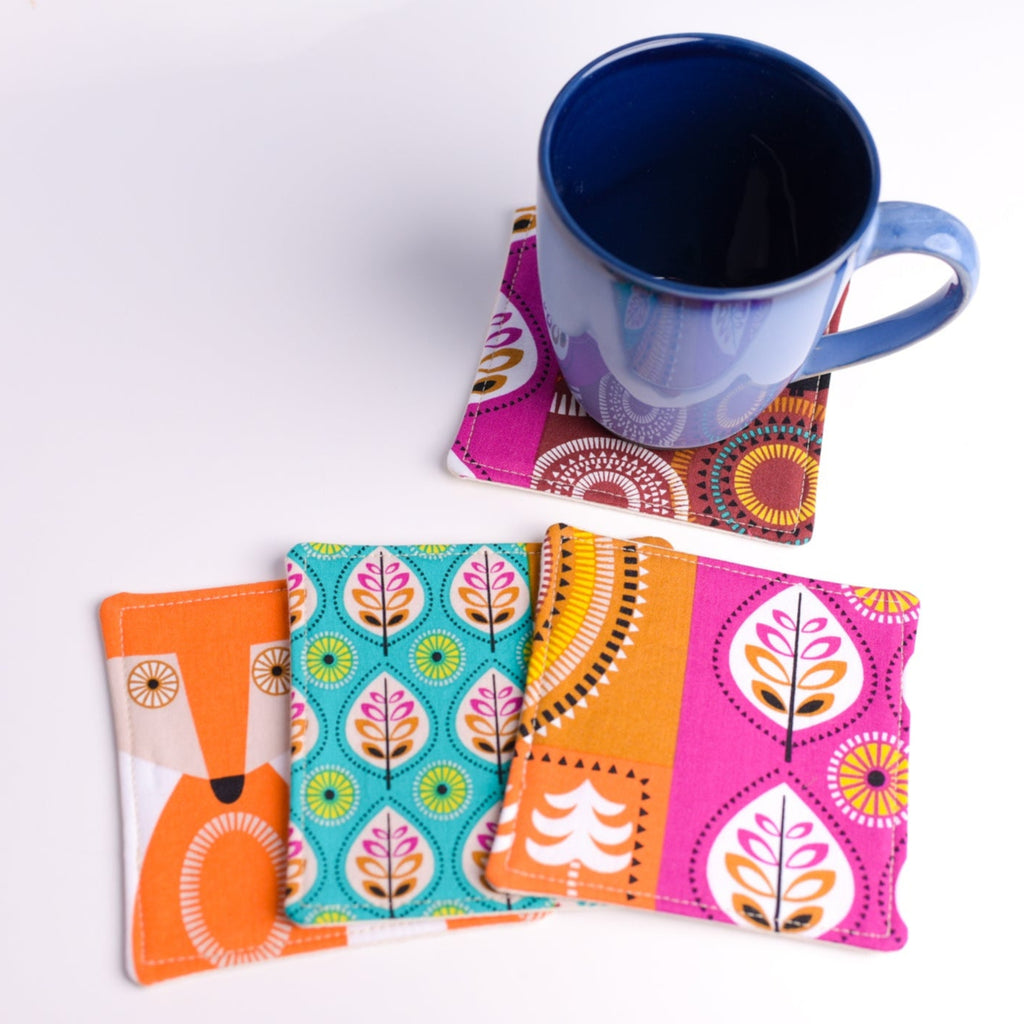 Colorful patterned coasters with a mug on a white background