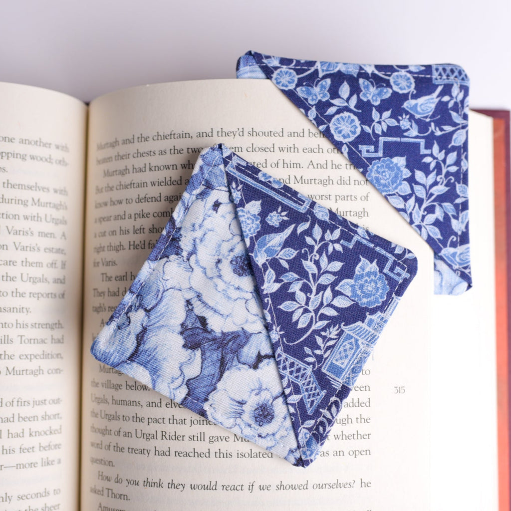 Blue floral fabric bookmarks on an open book