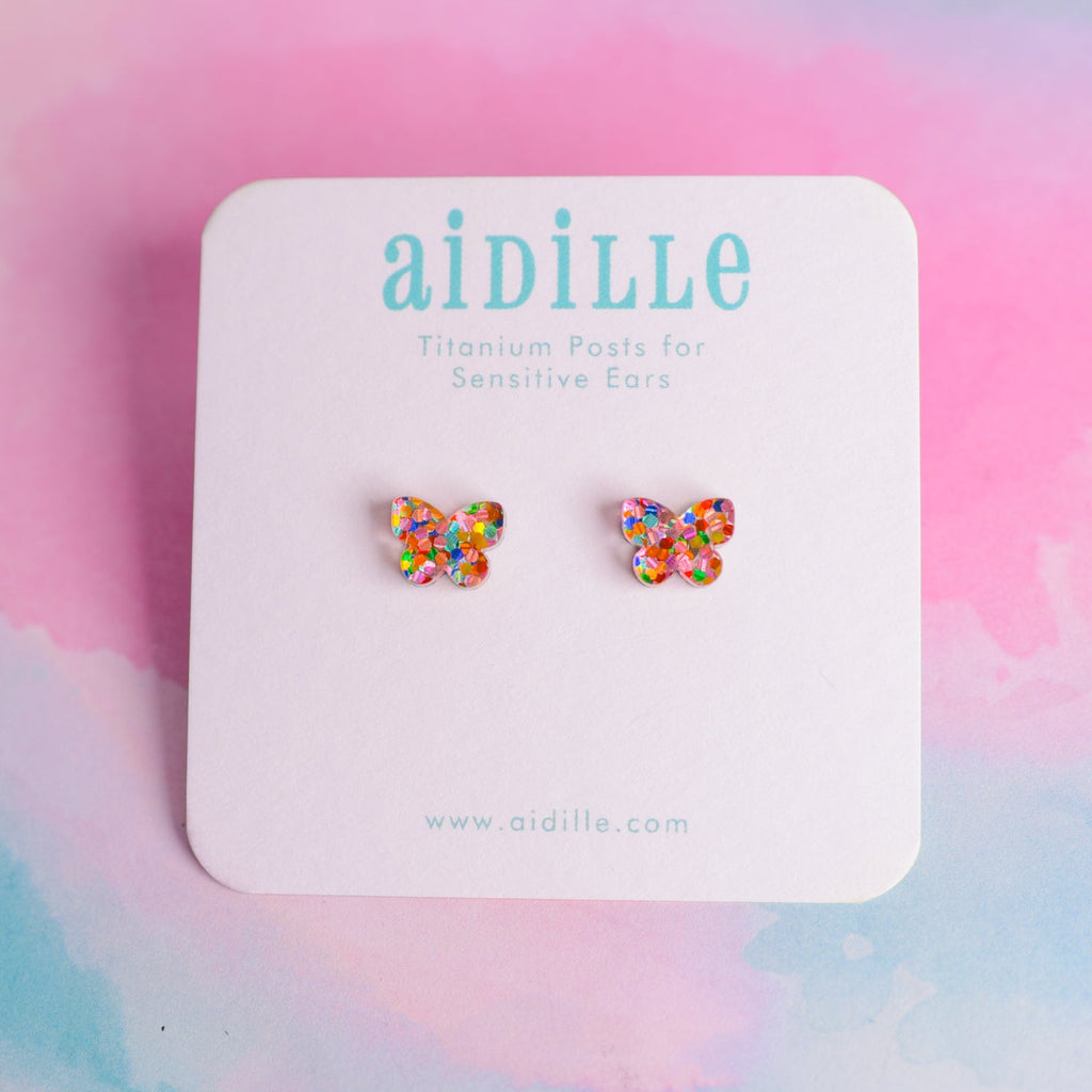 Butterfly earrings on a 'aidille' branded card with a colorful background
