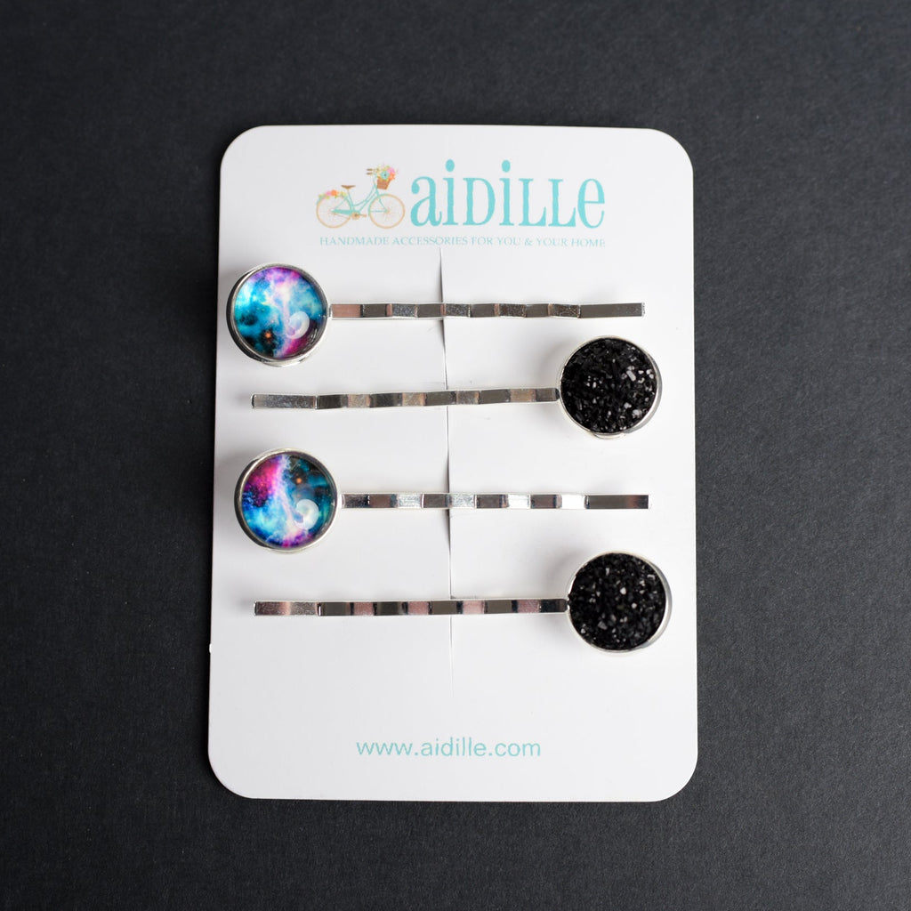Set of hair pins with colorful and black ends on a white card with 'aidille' branding, against a dark background.
