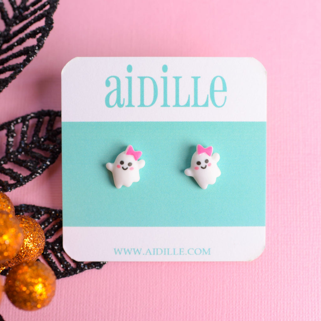 Ghost-shaped earrings on a 'aidille' branded card with a pink background