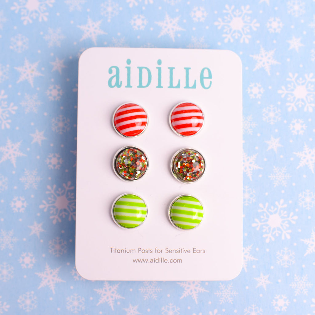Set of earrings on a 'aidille' branded card with a snowflake patterned background