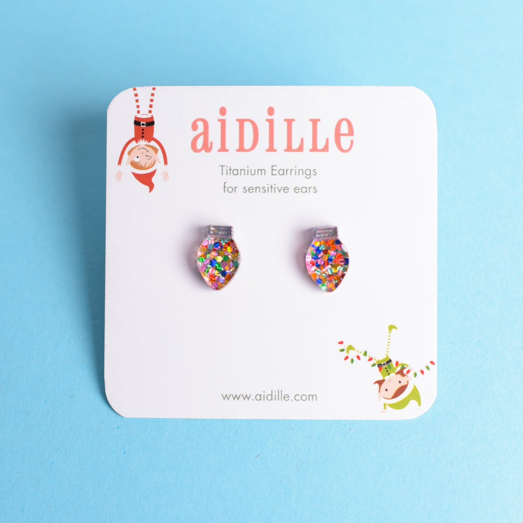 Colorful earrings on a 'aidille' branded card against a blue background