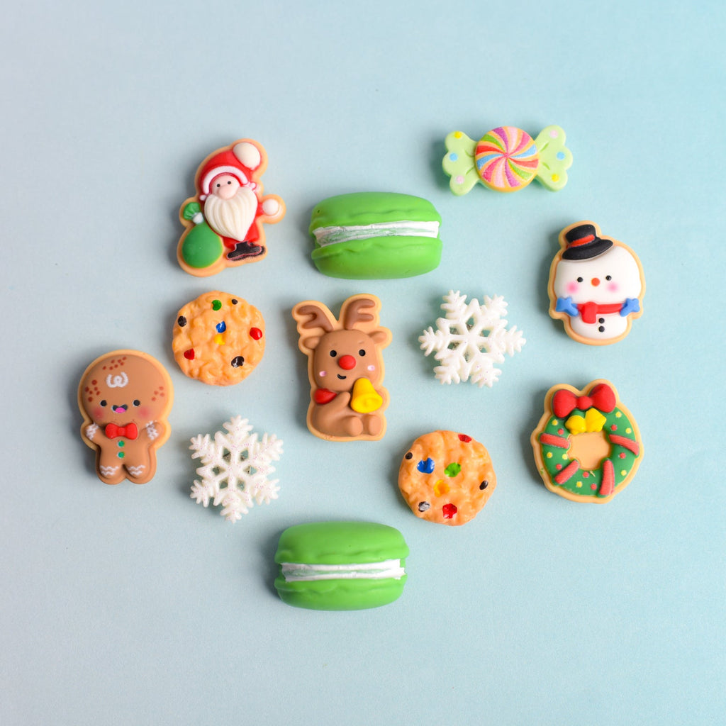Colorful cookies and macaron magnets on a light blue background