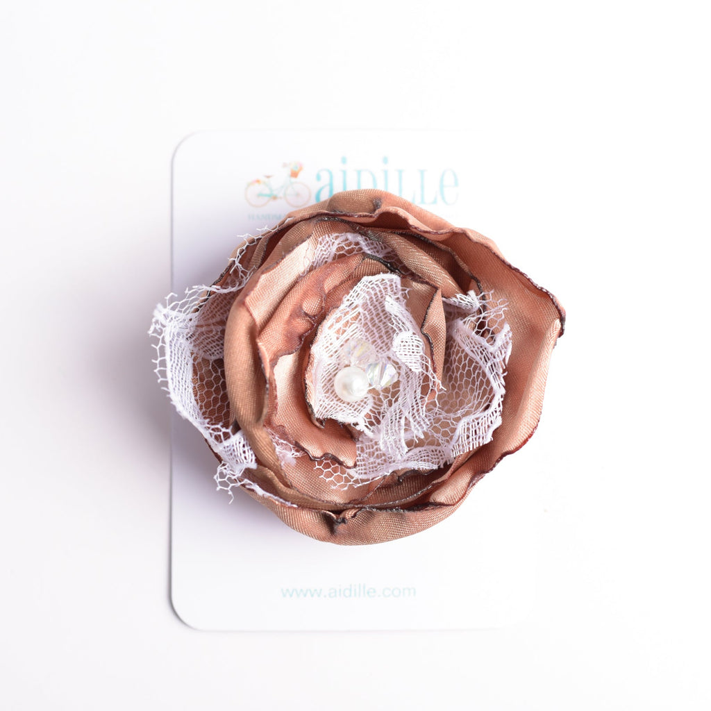 Rose gold flower-shaped hair clip on a white card with 'Boum! by Marianna' branding.