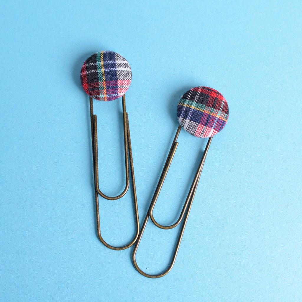 Two plaid paperclips on a blue background