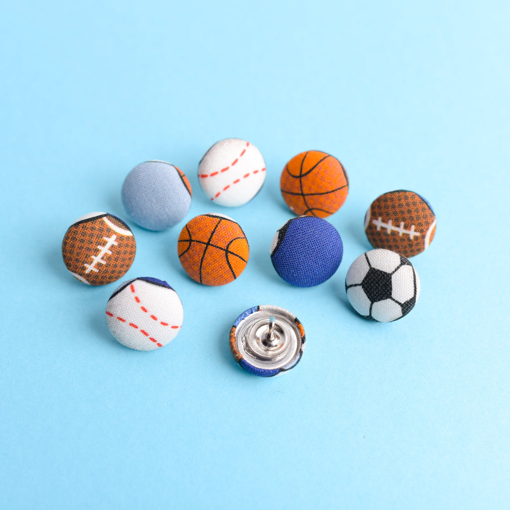 Colorful buttons shaped like sports balls on a blue background