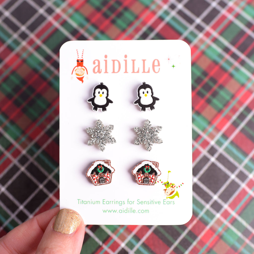 Set of earrings on a 'aidille' branded card against a plaid background