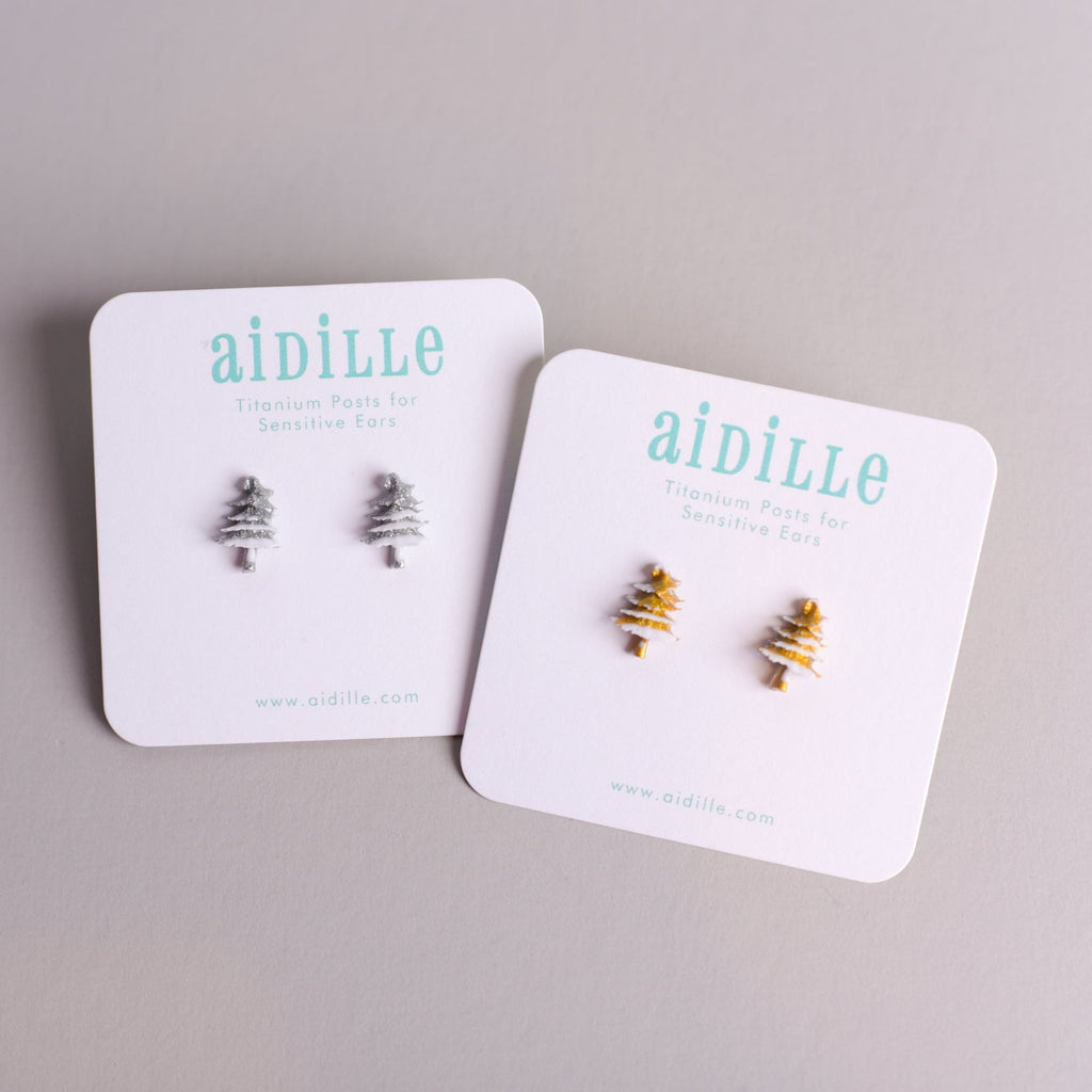 Two pairs of earrings on 'aidille' branded cards against a gray background